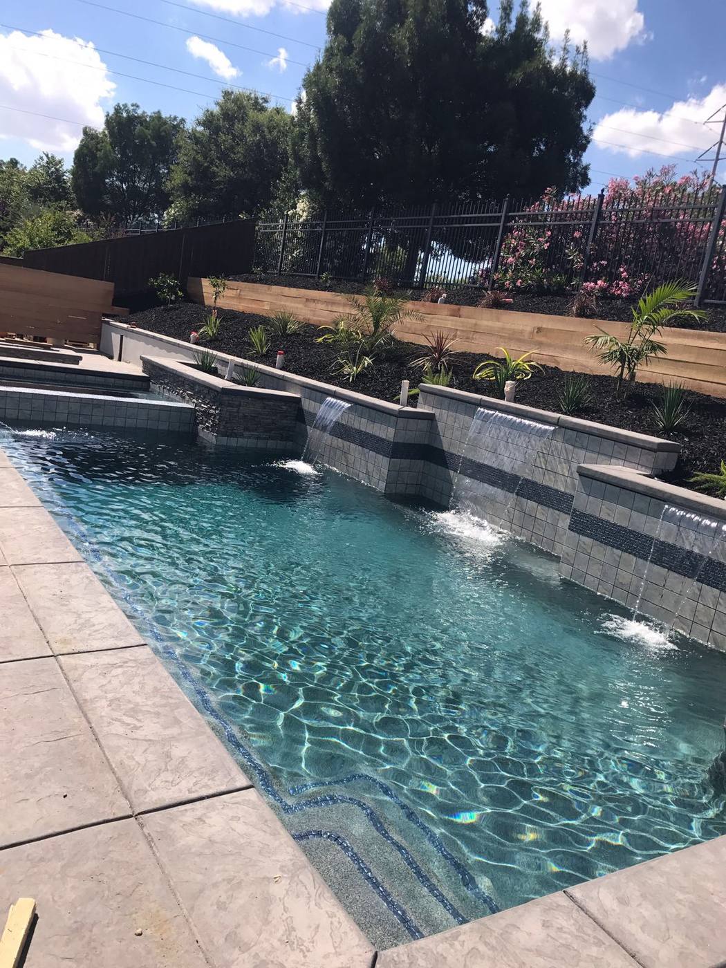 Custom landscaping design around swimming pool in Sacramento